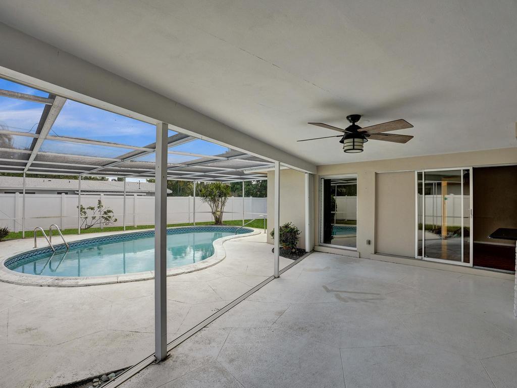 998 Southwest 5th Street Boca Raton, FL 33486 - Photo 48 of 55 a view of a livingroom with a ceiling fan and hardwood floor