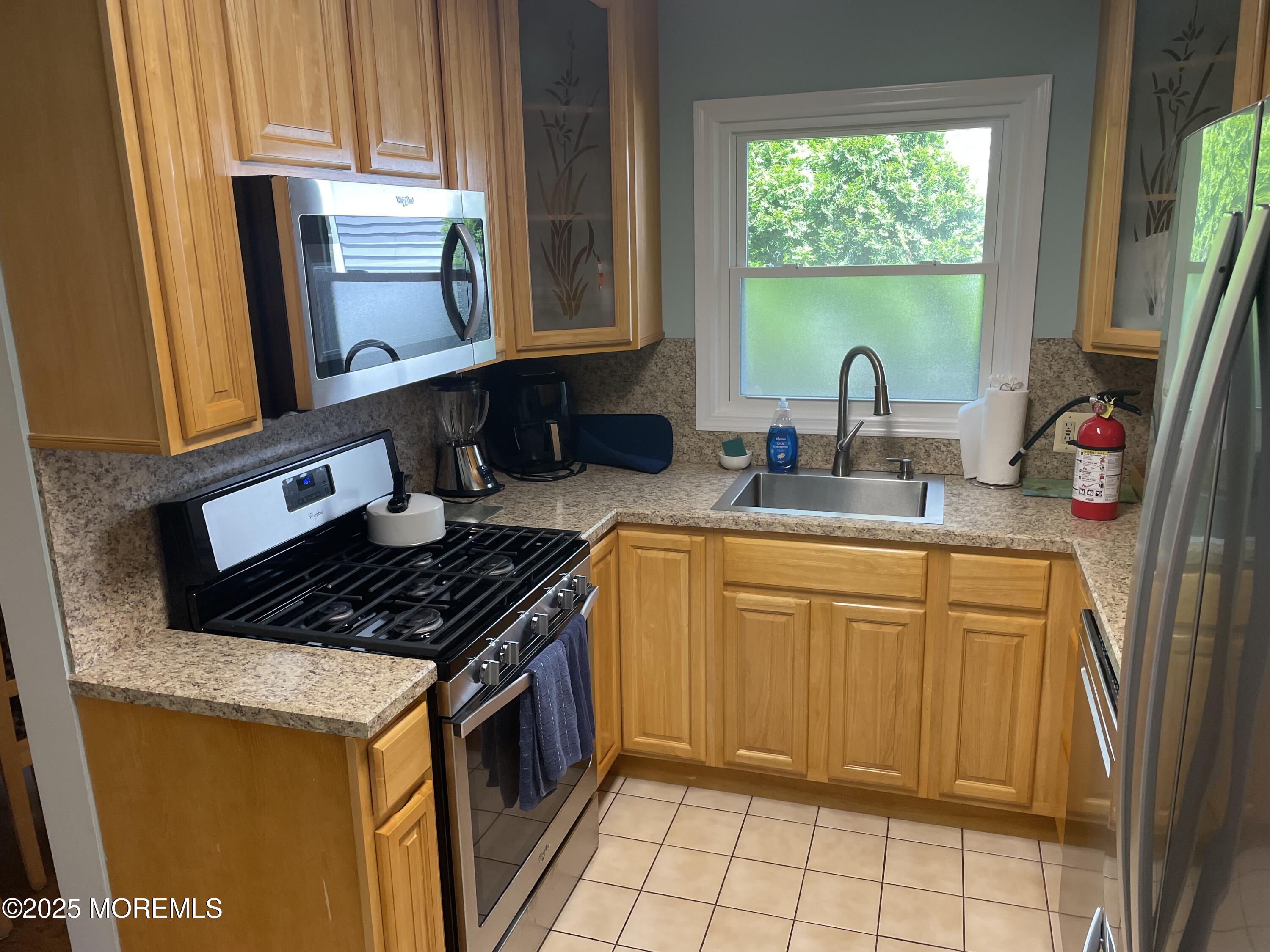 300 4th Avenue Spring Lake, NJ 07762 - Photo 12 of 40 a kitchen with stainless steel appliances granite countertop a sink stove and cabinets