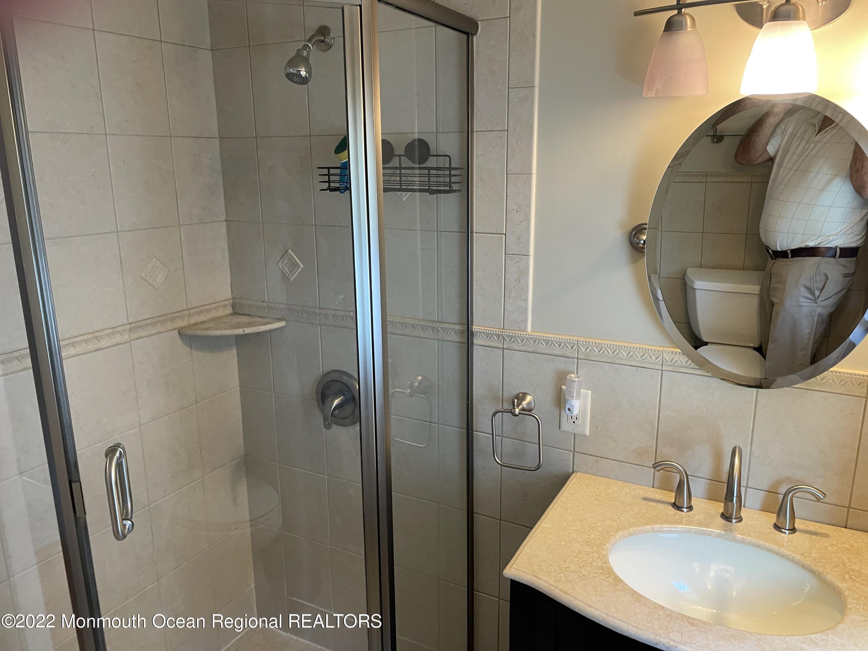 300 4th Avenue Spring Lake, NJ 07762 - Photo 36 of 40 a bathroom with a sink and a mirror