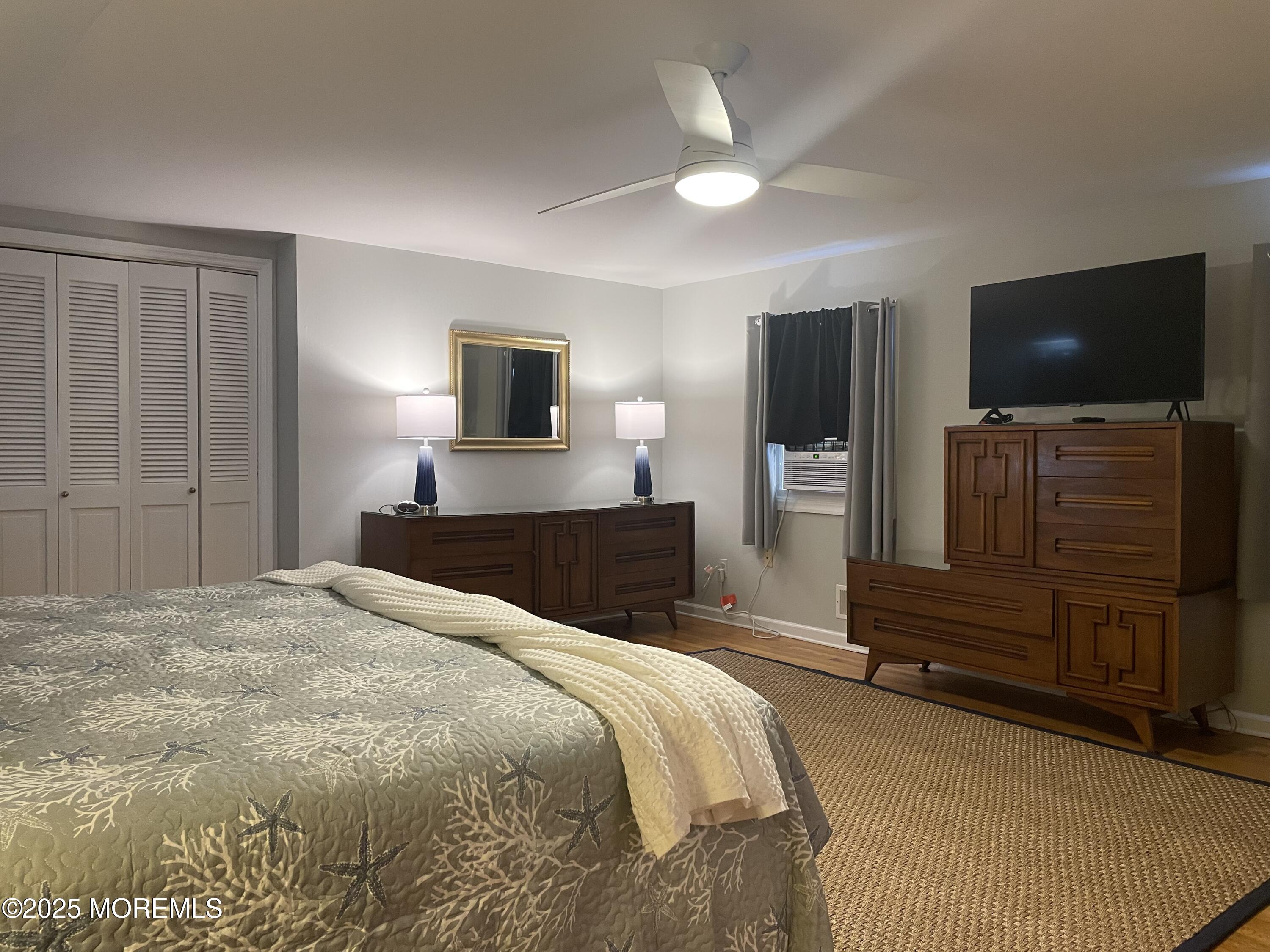 300 4th Avenue Spring Lake, NJ 07762 - Photo 37 of 40 a bedroom with a bed and a flat screen tv