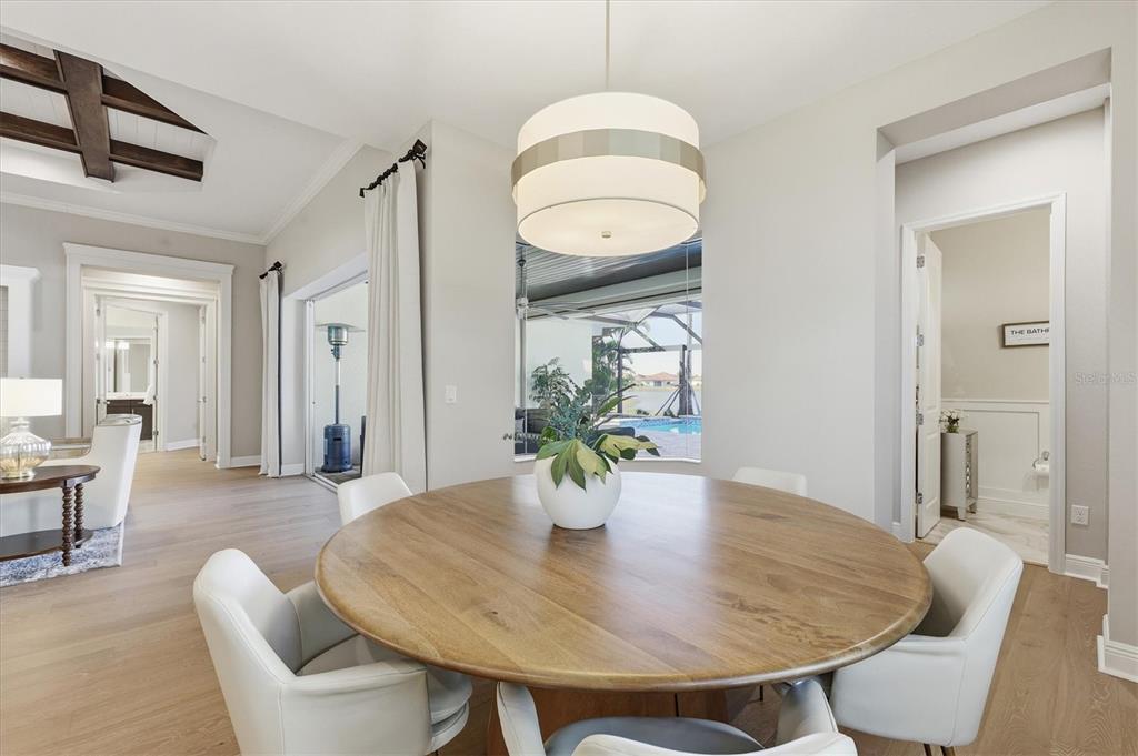 15909 Castle Park Terrace Lakewood Ranch, FL 34202 - Photo 12 of 66 a view of a dining room with furniture and wooden floor