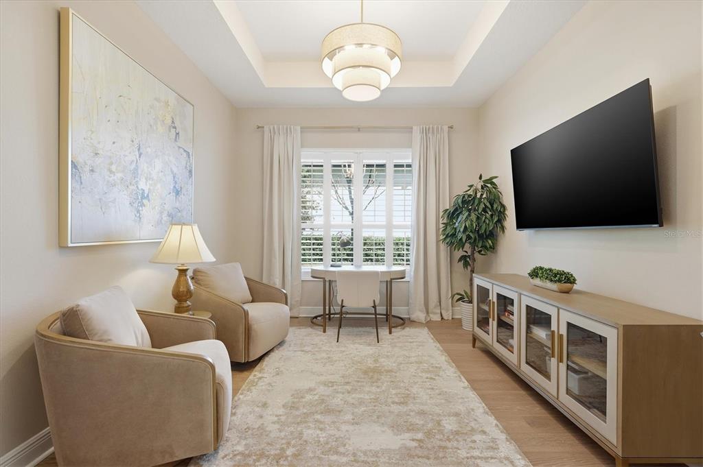 15909 Castle Park Terrace Lakewood Ranch, FL 34202 - Photo 18 of 66 a living room with furniture and a flat screen tv