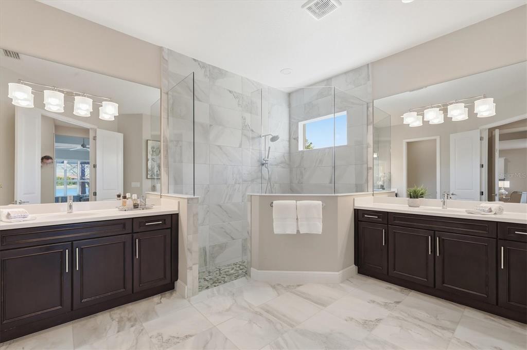 15909 Castle Park Terrace Lakewood Ranch, FL 34202 - Photo 23 of 66 a spacious bathroom with a double vanity sink mirror and double