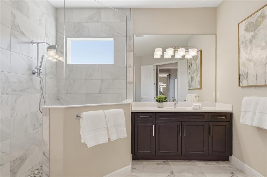 15909 Castle Park Terrace Lakewood Ranch, FL 34202 - Photo 25 of 66 a bathroom with a double vanity sink and a mirror