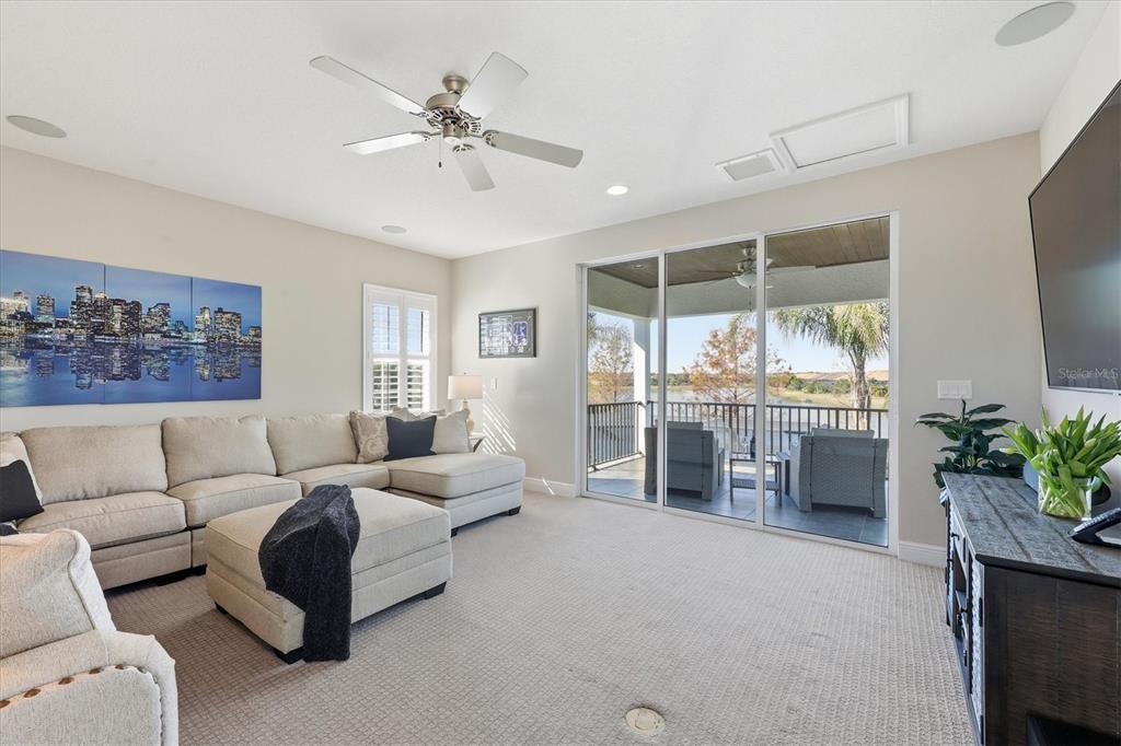 15909 Castle Park Terrace Lakewood Ranch, FL 34202 - Photo 32 of 66 a living room with furniture and a large window