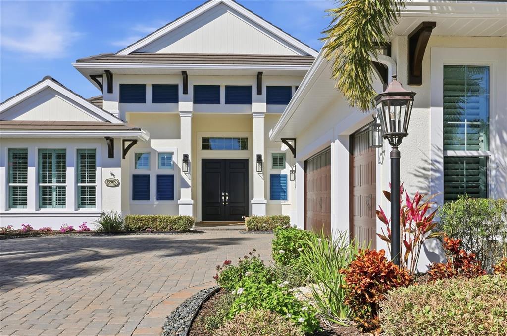 15909 Castle Park Terrace Lakewood Ranch, FL 34202 - Photo 4 of 66 a front view of a house with a yard and garage