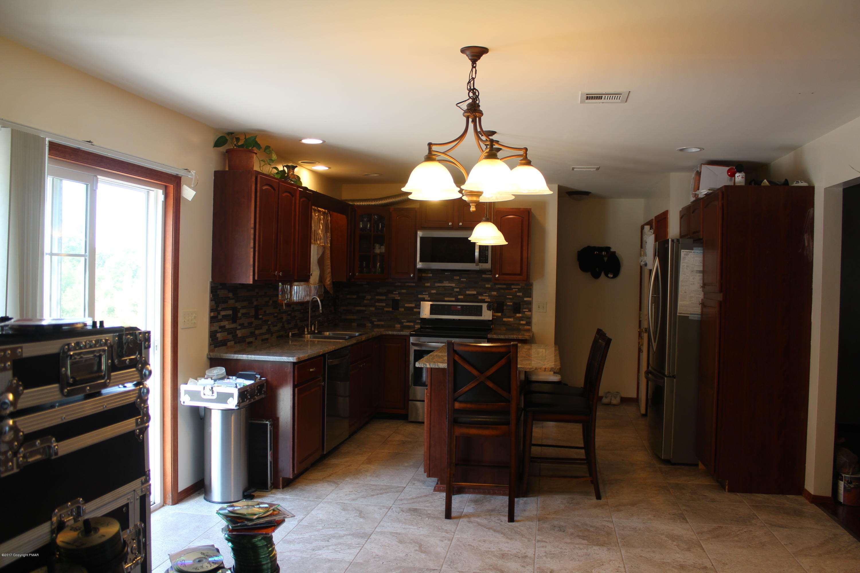 105 Pennbrook Road Stroudsburg, PA 18360 - Photo 9 of 34 a view of a dining room with furniture and chandelier