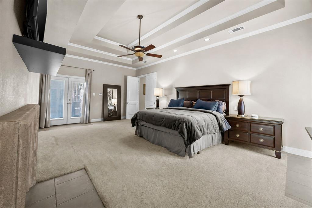 219 Mohundro Road Ferris, TX 75125 - Photo 17 of 40 a bedroom with a large bed and a ceiling fan