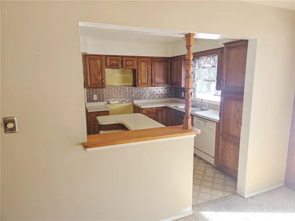 a kitchen with a sink and a refrigerator