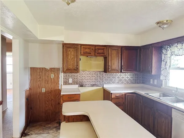 a kitchen with a refrigerator and a sink