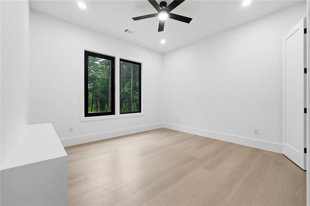 1563 Whitley Road Dacula, GA 30019 - Photo 22 of 44 wooden floor in an empty room with a window