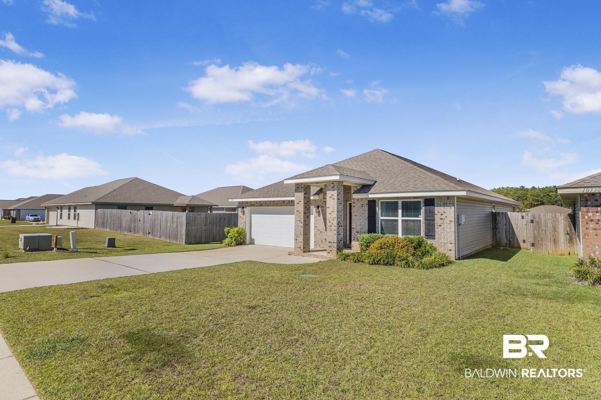 10738 Ridgeview Drive Mobile, AL 36608 - Photo 1 of 48 Ranch-style home with brick siding, concrete driveway, a garage, and a shingled roof