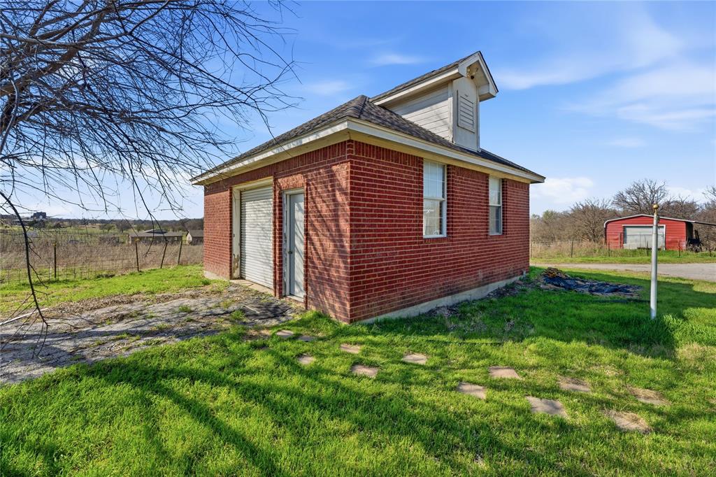 14529 County Road 511 Venus, TX 76084 - Photo 33 of 33 View of side of property featuring an outbuilding, a yard, and brick siding