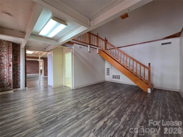 a view of an entryway with wooden floor