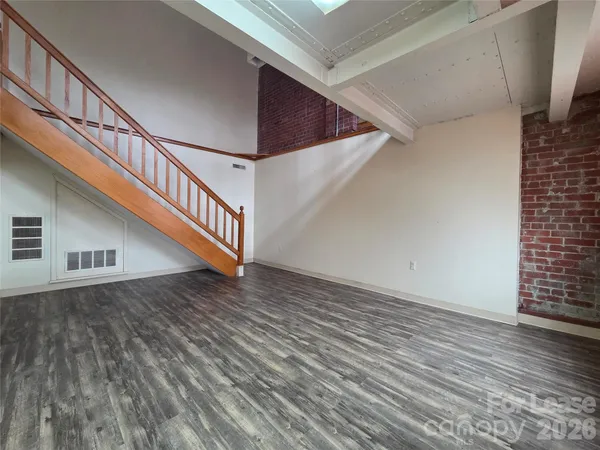 a view of an entryway with wooden floor