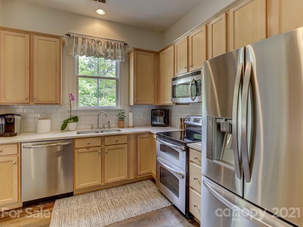 3035 Colonel Springs Way Fort Mill, SC 29708 - Photo 23 of 48 a kitchen with stainless steel appliances a refrigerator sink and cabinets