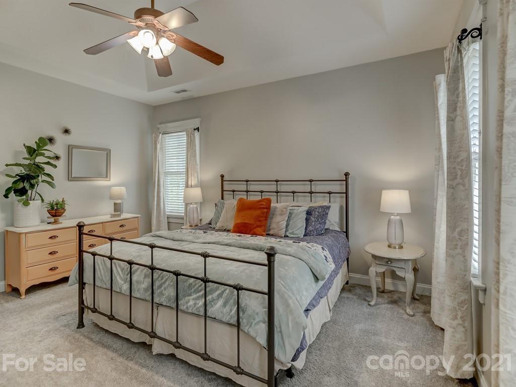 3035 Colonel Springs Way Fort Mill, SC 29708 - Photo 31 of 48 a bedroom with a bed a chandelier and dresser
