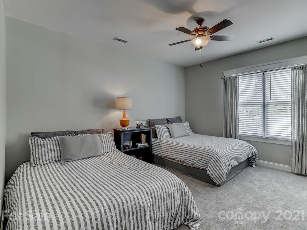 3035 Colonel Springs Way Fort Mill, SC 29708 - Photo 36 of 48 a bedroom with two beds and a chandelier