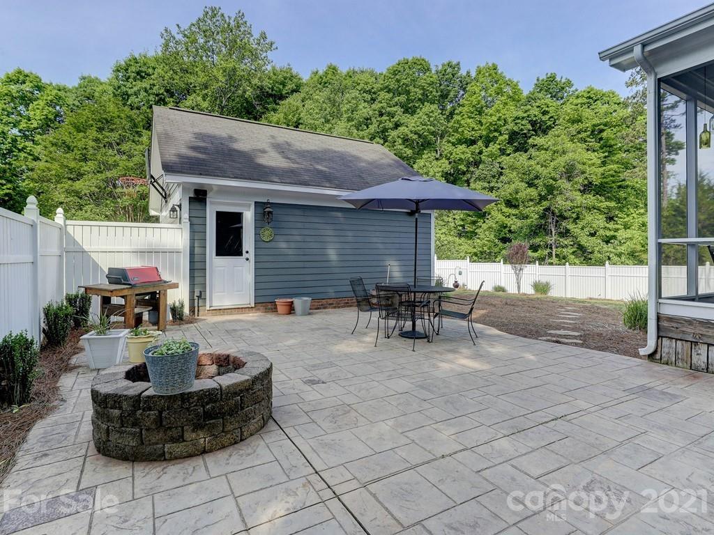 3035 Colonel Springs Way Fort Mill, SC 29708 - Photo 44 of 48 a view of a patio with table and chairs potted plants with wooden fence