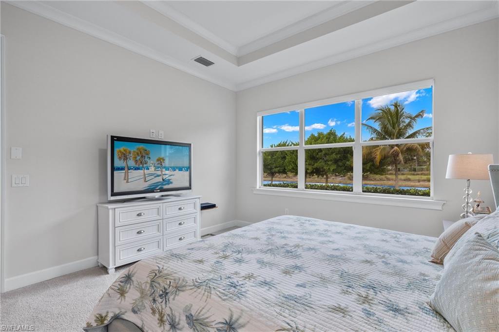 5797 Anegada Drive Naples, FL 34113 - Photo 16 of 40 a bedroom with a bed and a flat screen tv