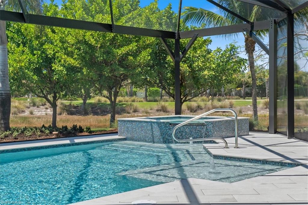 5797 Anegada Drive Naples, FL 34113 - Photo 23 of 40 a backyard of a house with table and chairs