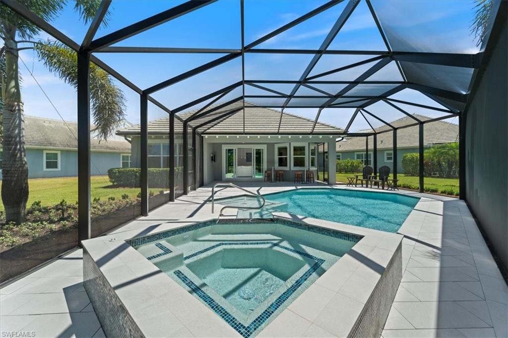 5797 Anegada Drive Naples, FL 34113 - Photo 24 of 40 a view of a swimming pool with a porch