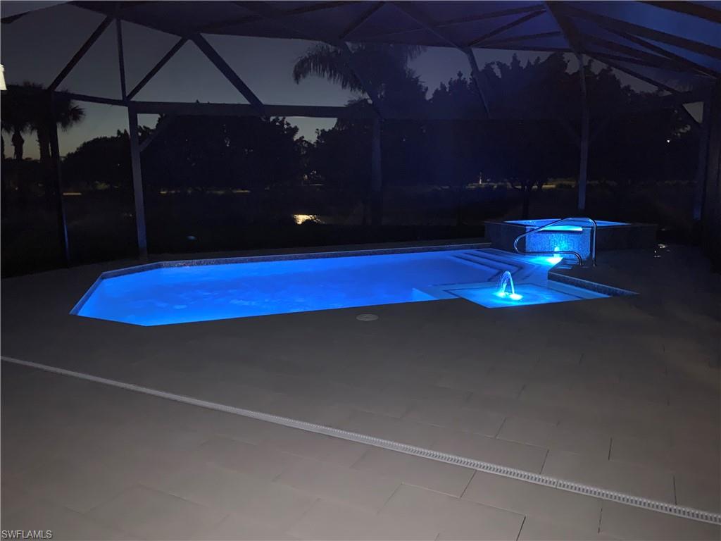 5797 Anegada Drive Naples, FL 34113 - Photo 26 of 40 a room with pool table and chandelier