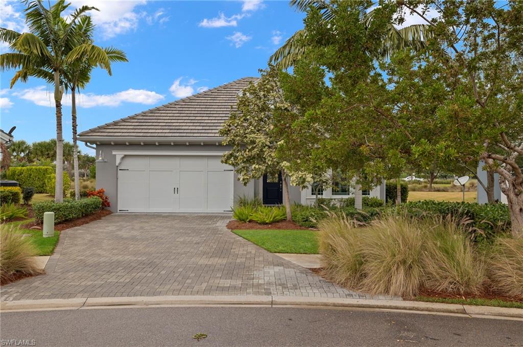 5797 Anegada Drive Naples, FL 34113 - Photo 28 of 40 a front view of a house with a yard and garage