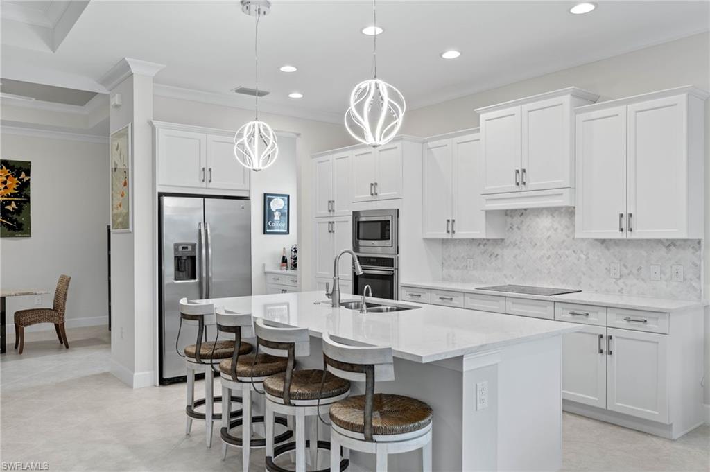 5797 Anegada Drive Naples, FL 34113 - Photo 7 of 40 a kitchen with a sink cabinets and window