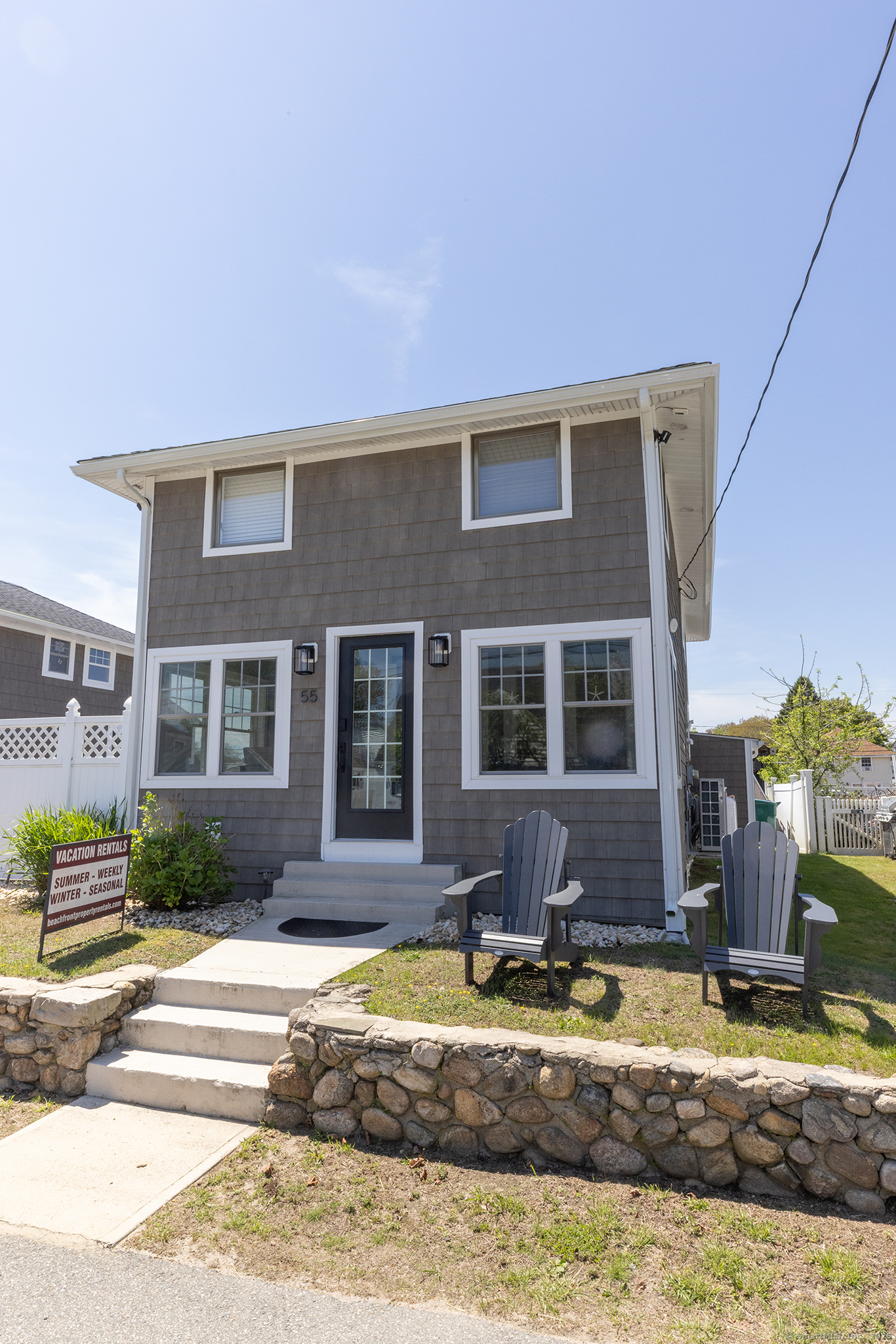 55 Swan Avenue Old Lyme, CT 06371 - Photo 1 of 40 a front view of a house with a yard