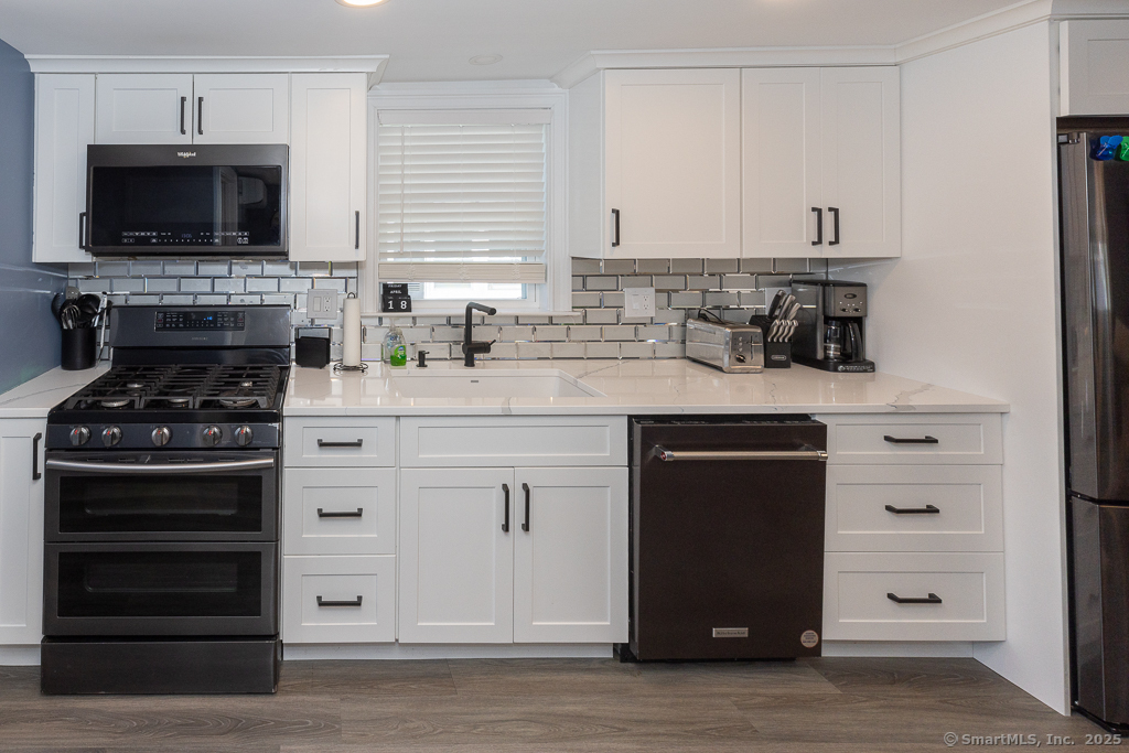 55 Swan Avenue Old Lyme, CT 06371 - Photo 13 of 40 a kitchen with granite countertop a stove and a microwave