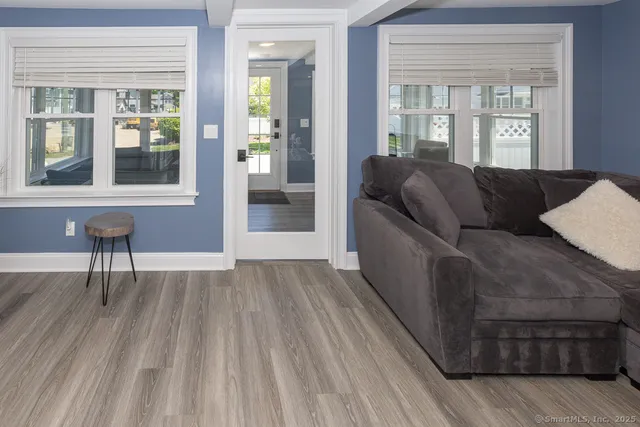 a living room with furniture and a wooden floor