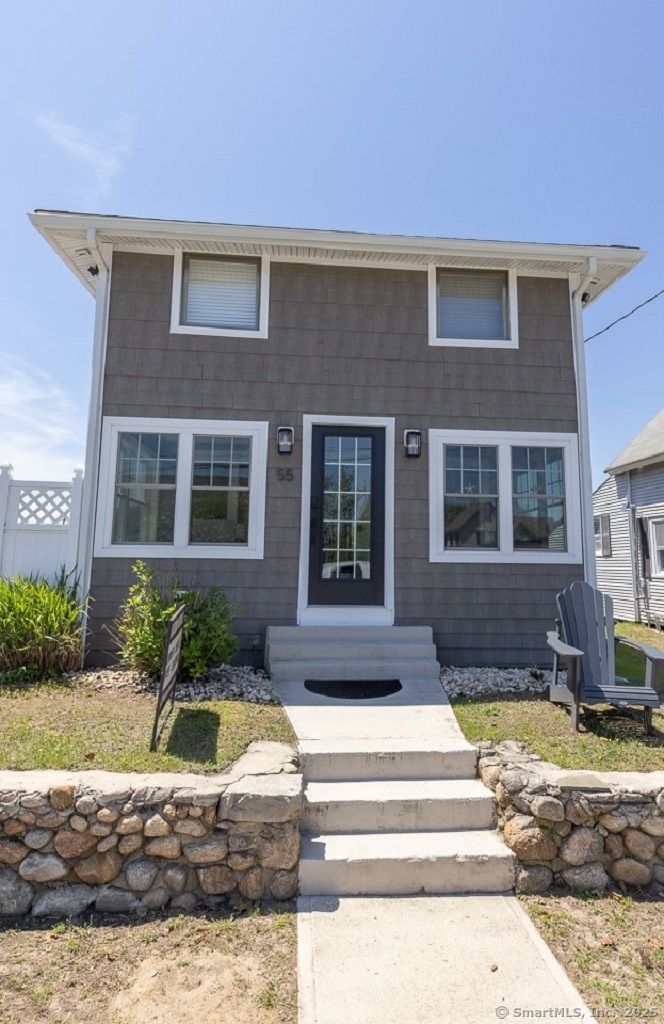 55 Swan Avenue Old Lyme, CT 06371 - Photo 2 of 40 a front view of a house with swimming pool and glass windows