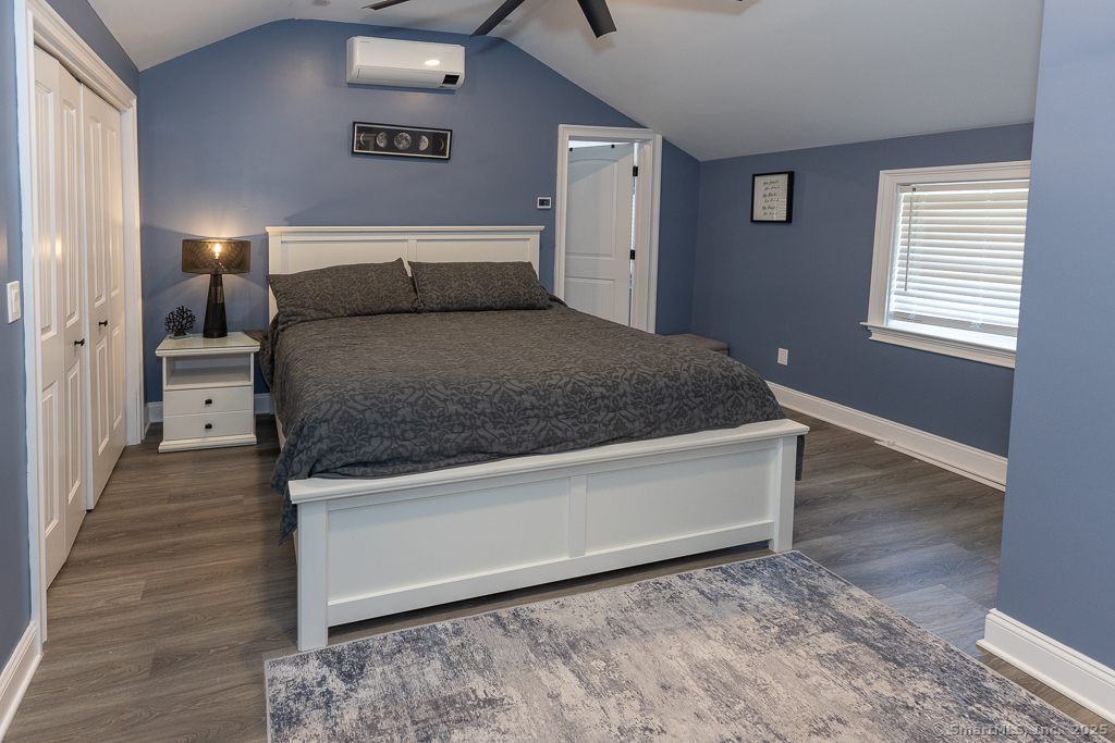 55 Swan Avenue Old Lyme, CT 06371 - Photo 23 of 40 a bedroom with a bed and wooden floor