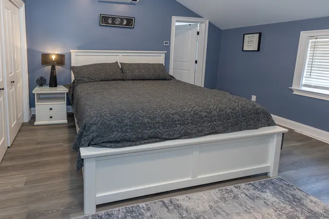 a bedroom with a bed and a window