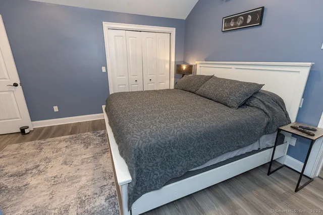 a bed sitting in a bedroom next to a window