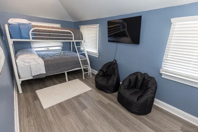 a bedroom with two beds and a window