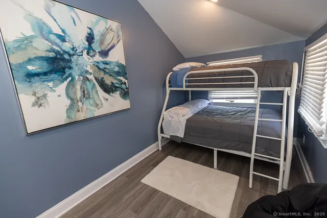 a bedroom with a bed and a picture on the wall