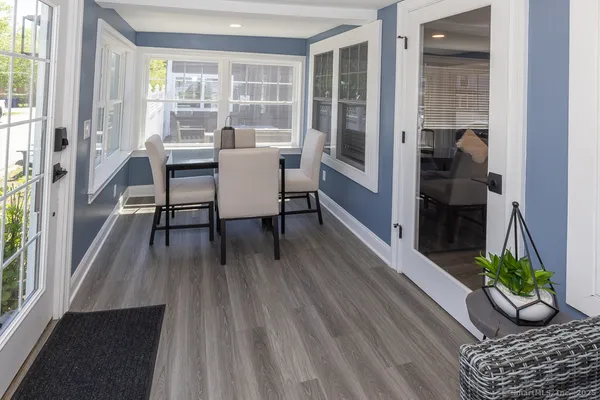 a view of a dining room with furniture window and wooden floor
