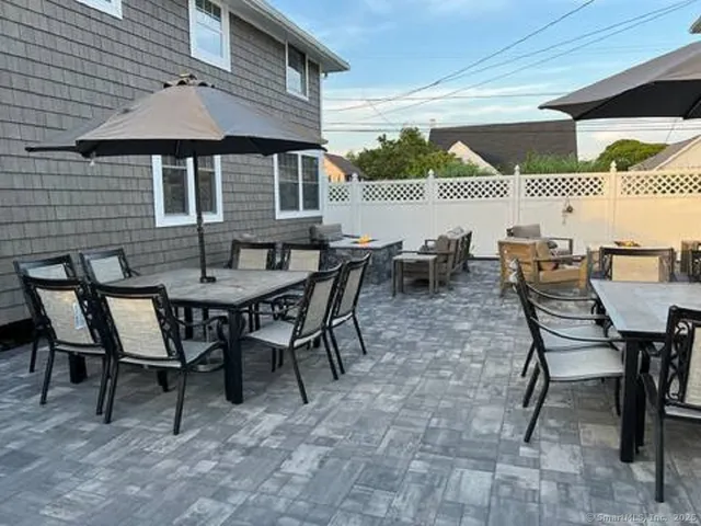 a dining area with a table and chairs