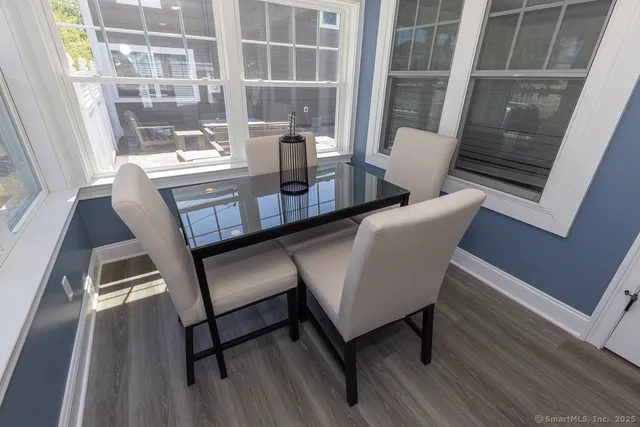 a view of a dining room with furniture window and wooden floor