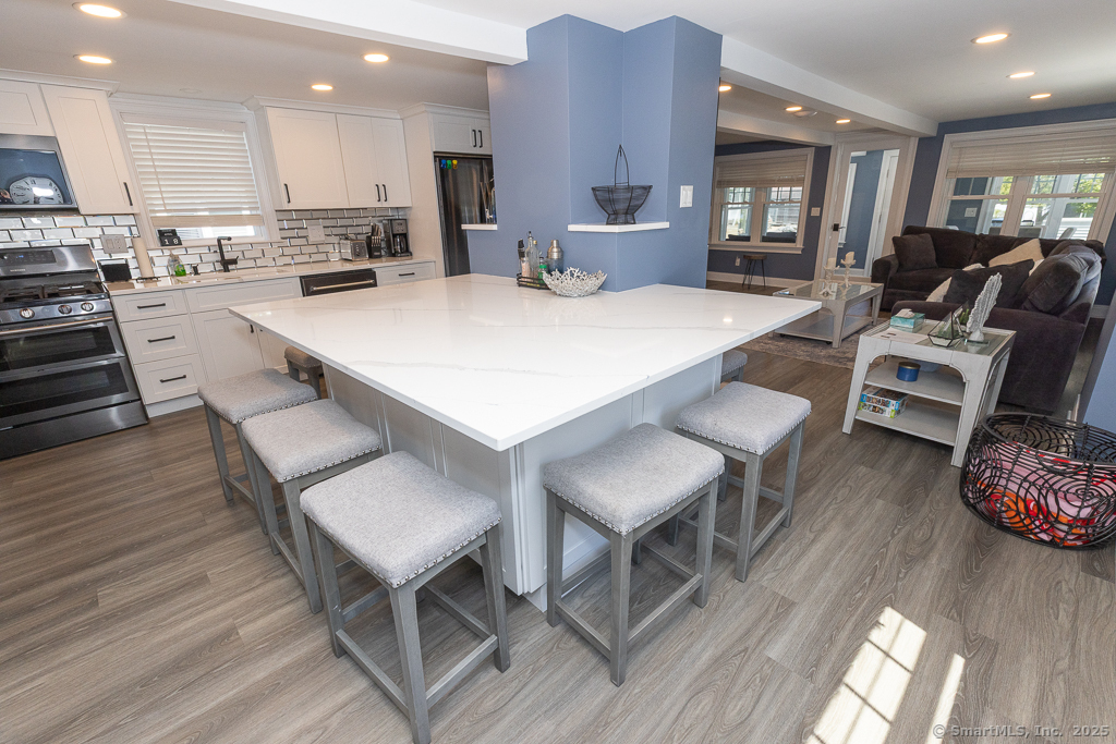 55 Swan Avenue Old Lyme, CT 06371 - Photo 10 of 40 a large kitchen with a table and chairs