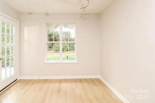 a view of kitchen with refrigerator and wooden floor