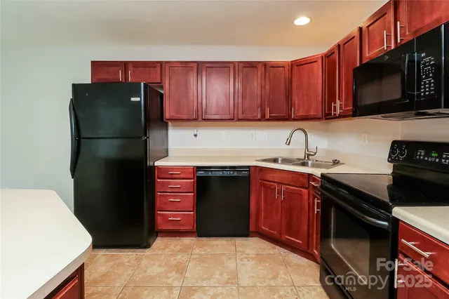 a kitchen with granite countertop a refrigerator stove and microwave