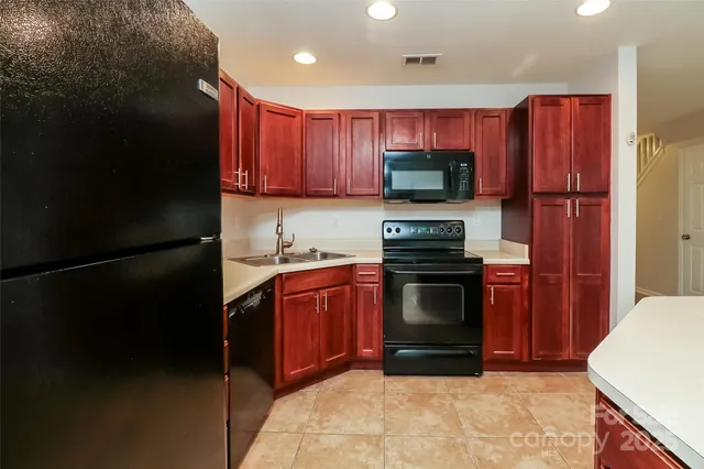 an empty room with a window and a ceiling fan