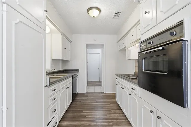 a kitchen with stainless steel appliances a stove microwave and a refrigerator