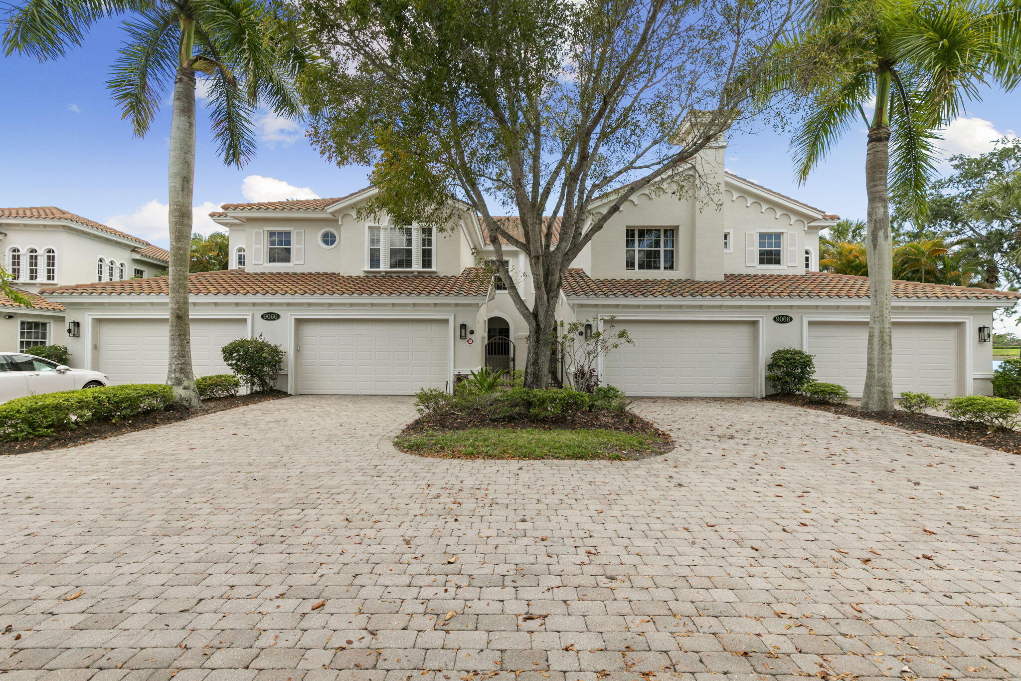 9066 Cascada Way, Unit 101 Naples, FL 34114 - Photo 2 of 51 a front view of a house with garden
