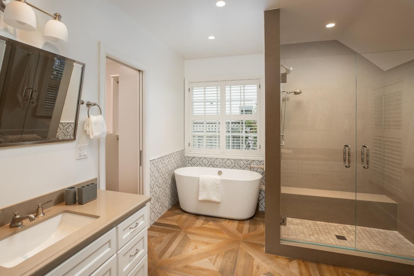 166 Seminary Drive Menlo Park, CA 94025 - Photo 19 of 41 a bathroom with a tub a sink and a large mirror