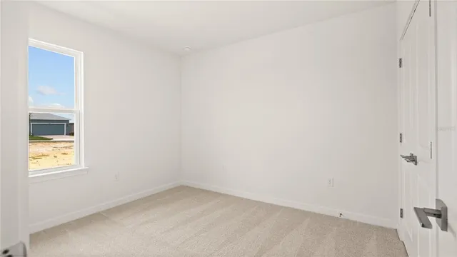 a view of an empty room and a window