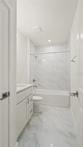 a bathroom with a toilet a sink and bathtub